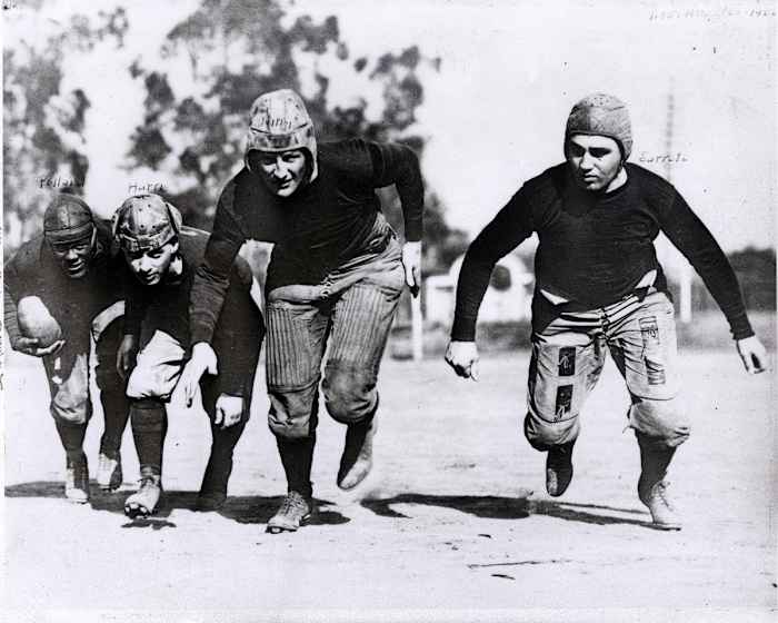 The Akron Pros run hunched over